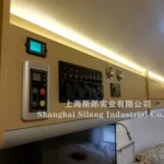 Airstream Allie pop-up caravan interior showing control panel, toggle switches, round gauges and warm LED accent lighting
