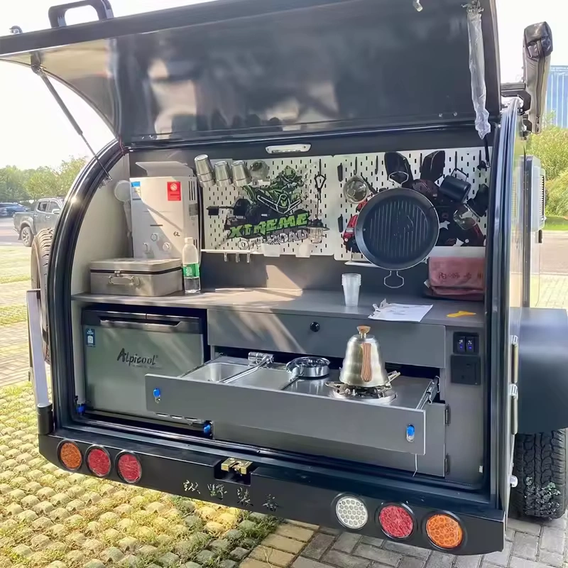 Cindy Cinema mini caravan rear outdoor kitchen with pull-out stove, sink, Alpicool fridge and hanging utensils for camping