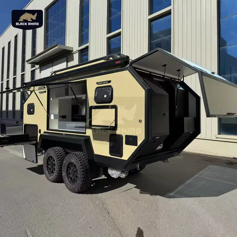 The Lucy Lux Black Rhino-2A hybrid caravan features an expandable outdoor kitchen, rugged off-road tires, and setup.