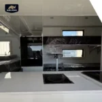 Interior view of the Lucy Lux hybrid caravan featuring a modern kitchen counter, bunk beds, and premium appliances.