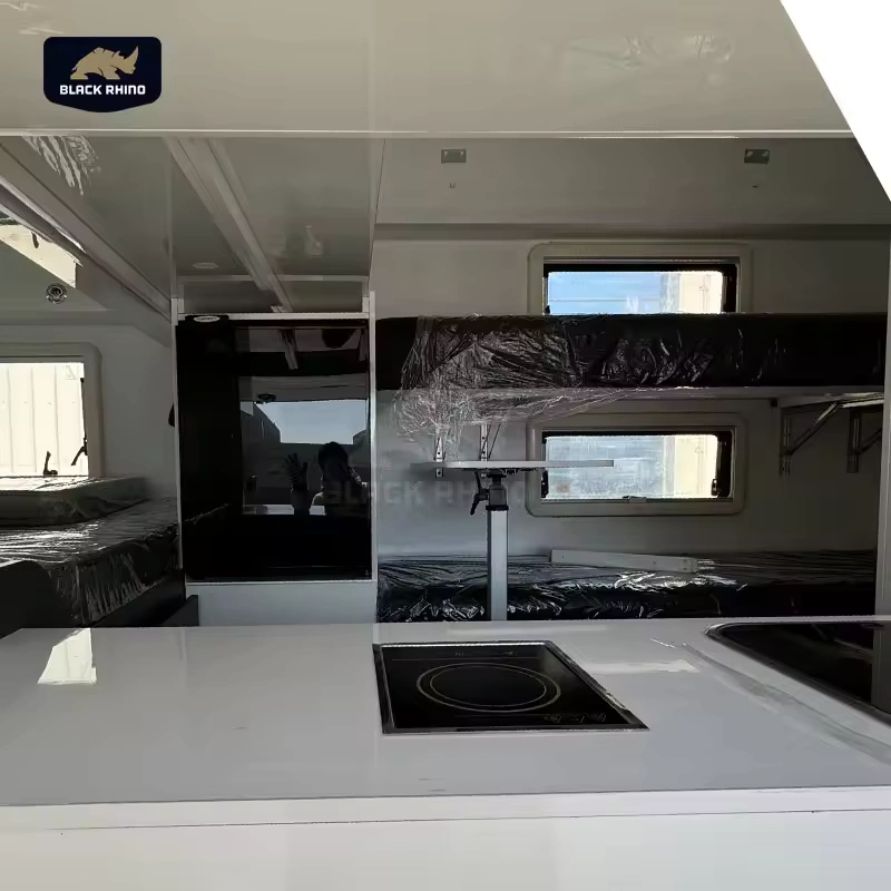Interior view of the Lucy Lux hybrid caravan featuring a modern kitchen counter, bunk beds, and premium appliances.