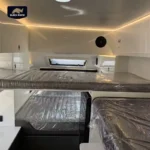 Modern interior of a Lucy Lux hybrid caravan featuring bunk beds and luxury finishes for comfortable off-road camping.
