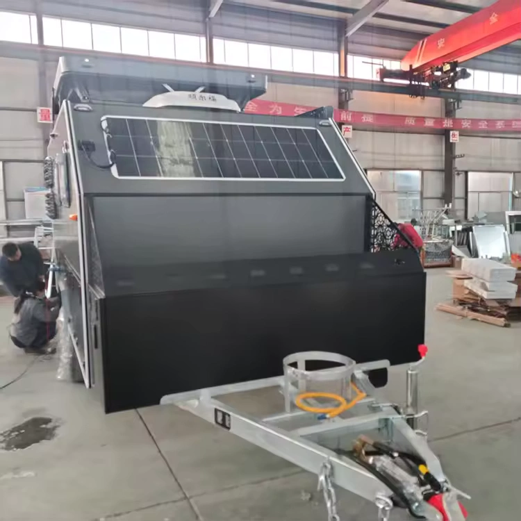 Popup Poppy off-road mini caravan in factory showing rooftop solar panel, hot-dipped galvanised chassis and front box