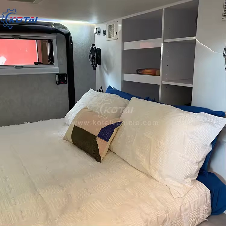 A view inside the cozy and modern queen-size sleeping area of the Rugged Roy off-road teardrop travel trailer caravan.