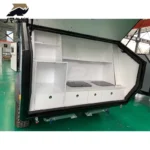 The Shark I off-road camper trailer features a modern slide-out exterior kitchen with premium white storage cabinets.