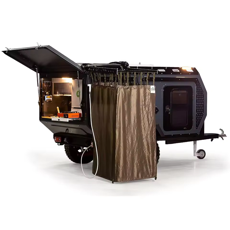 Swiss Army Andy off-road camper trailer showing the rear outdoor kitchen and privacy shower curtain setup.