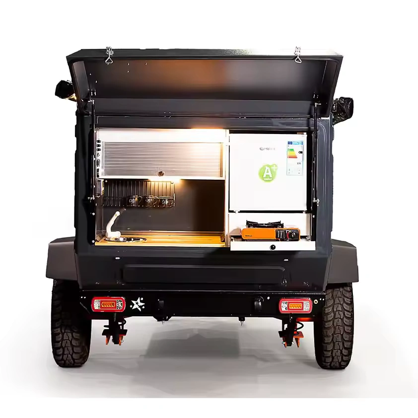 Swiss Army Andy off-road camper trailer rear view showing the integrated outdoor kitchen with fridge and stove setup.