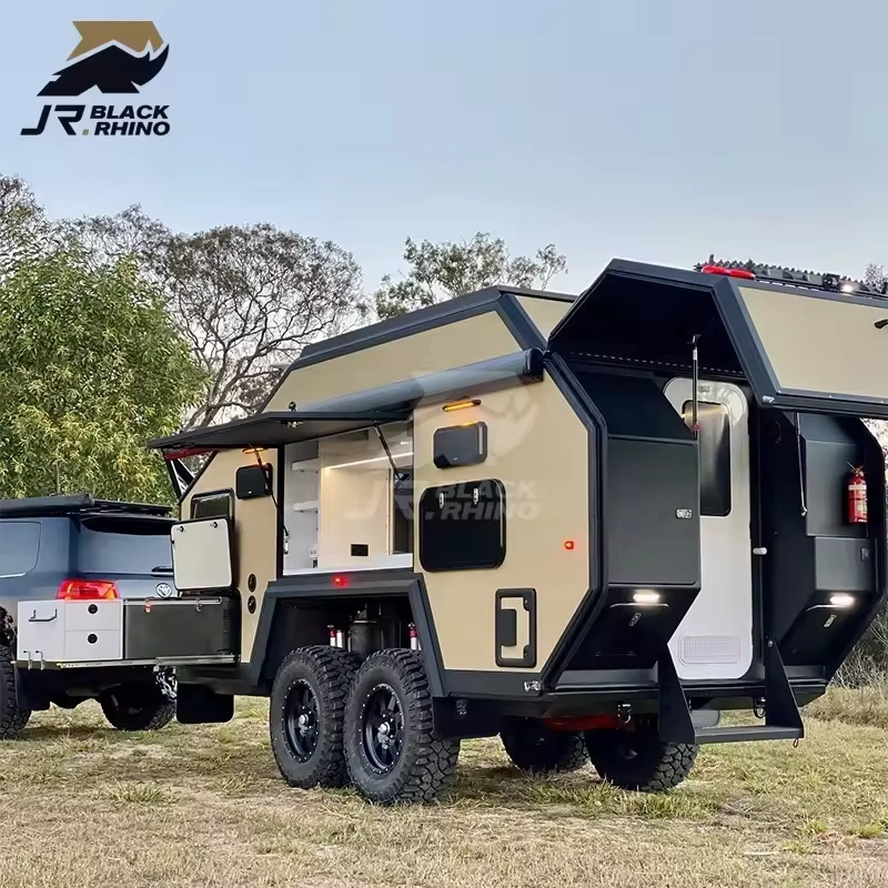The Terminator Black Rhino-2A off-road hybrid caravan parked outdoors with its kitchen and storage compartments open.