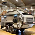 The Terminator (CODE 2671) Black Rhino-2A MAX hybrid off-road camper trailer inside a manufacturing facility.