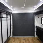 Modern interior of the Toy Boy camper trailer featuring premium cabinetry and wooden flooring for off-grid adventures.
