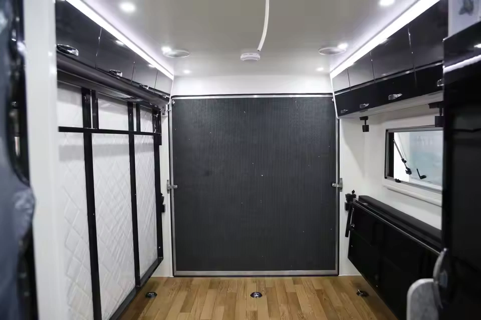 Modern interior of the Toy Boy camper trailer featuring premium cabinetry and wooden flooring for off-grid adventures.