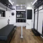 Modern interior view of the Toy Boy caravan featuring a convertible dining area, sleeping space, and premium finishes.