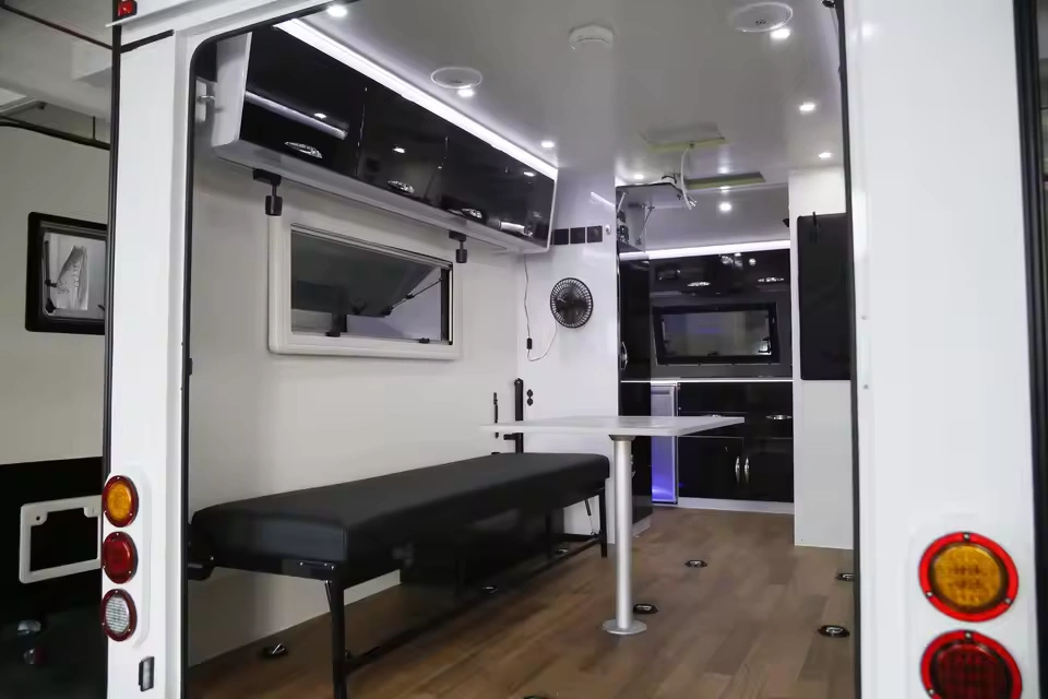 Modern interior view of the Toy Boy off-road toy hauler showing the comfortable dining area and bench seating setup.