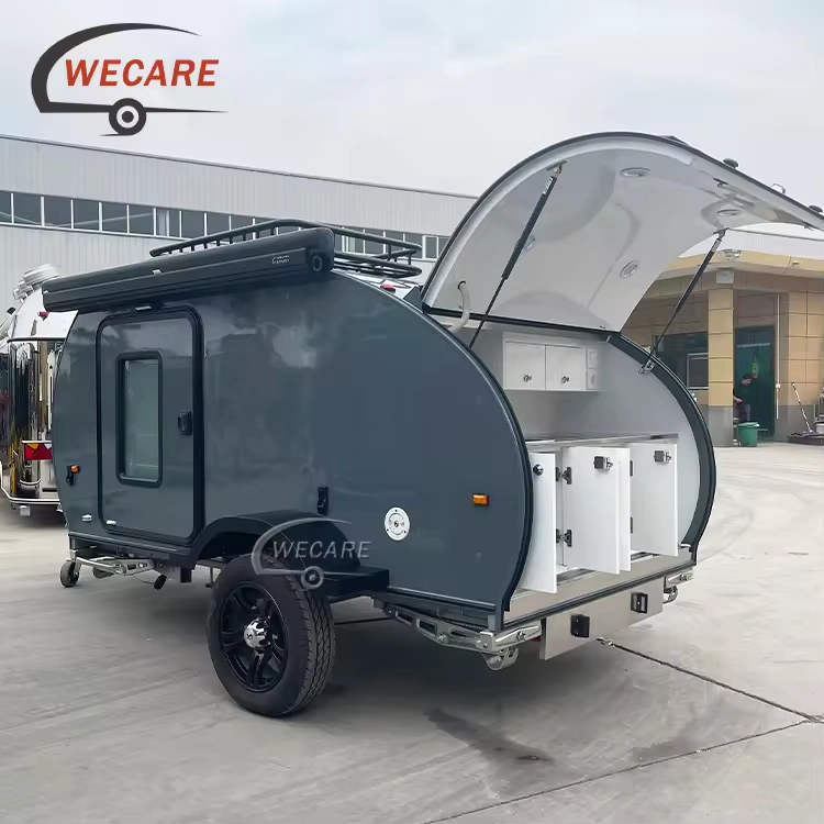 Side profile of the WECARE Basic Teardrop Mini Caravan with its rear hatch open showing kitchen storage compartments