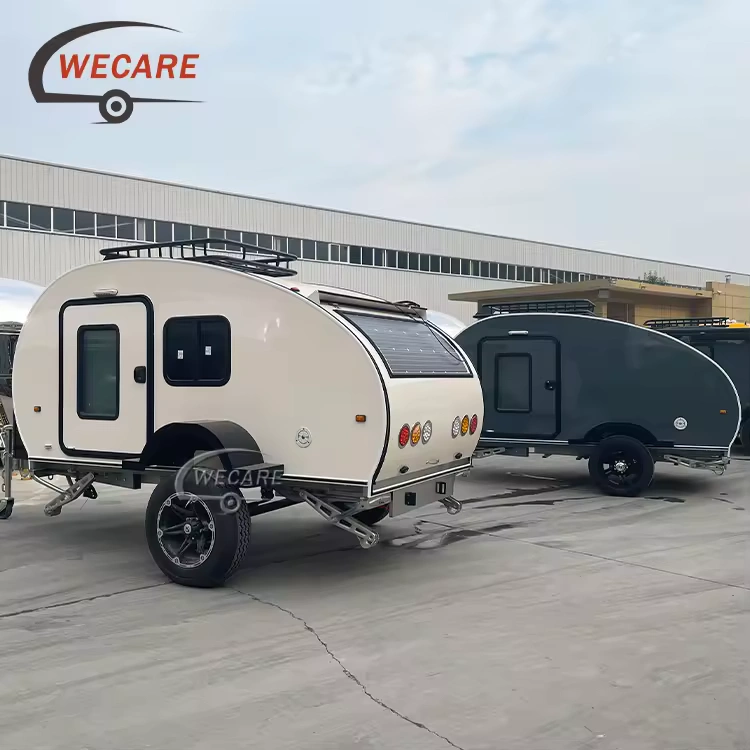 Two WECARE off-road teardrop caravans parked outside with rooftop solar panels and durable all-terrain tires for camping.