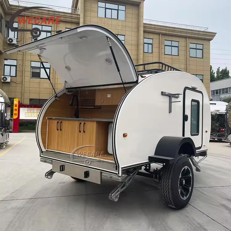White offroad teardrop travel caravan with an open rear slide-out kitchen for sale at China Caravans