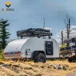 Cody Compact (CODE 2688) mini caravan featuring an aluminum body and rooftop tent parked in a rugged outdoor setting.