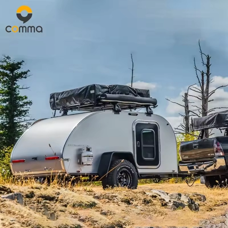 Cody Compact (CODE 2688) mini caravan featuring an aluminum body and rooftop tent parked in a rugged outdoor setting.