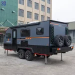 Side profile view of a grey TF series off-road caravan featuring dual axles and rugged all-terrain tires for travel.