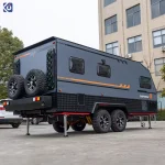 Modern TF series off-road caravan with dual axles, rugged tires, and black and grey exterior parked in an outdoor lot.